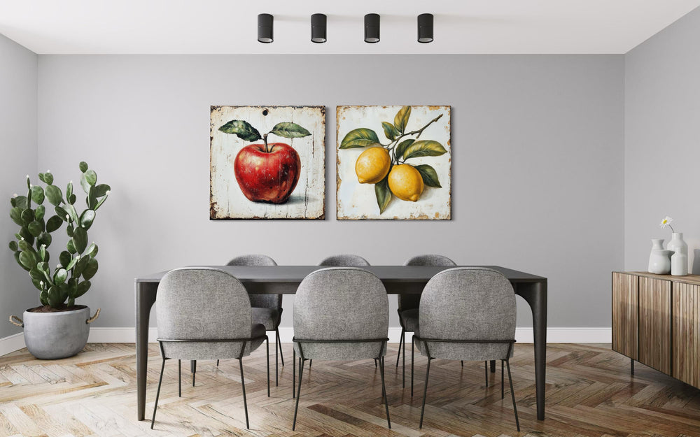 Vintage fruit wall art set featuring a red apple and yellow lemons on a dining room wall.