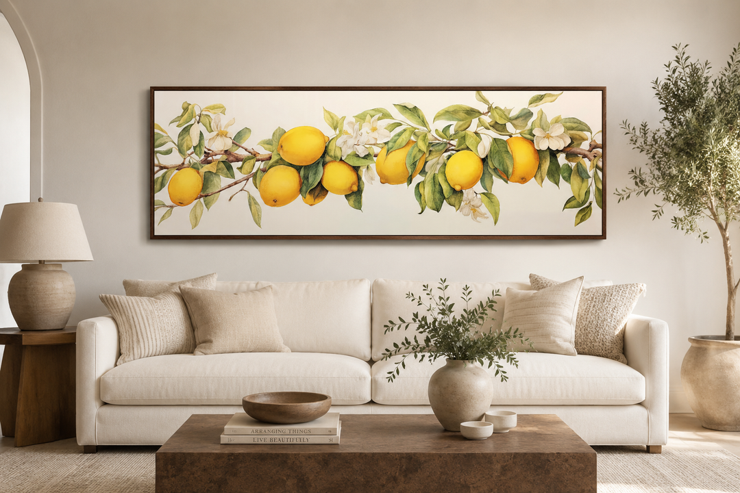 Vintage lemon tree panoramic framed canvas wall art hanging above a white sofa in a neutral room.