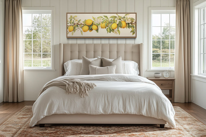 Vintage lemon tree panoramic framed canvas wall art hanging above a bed in a neutral bedroom.