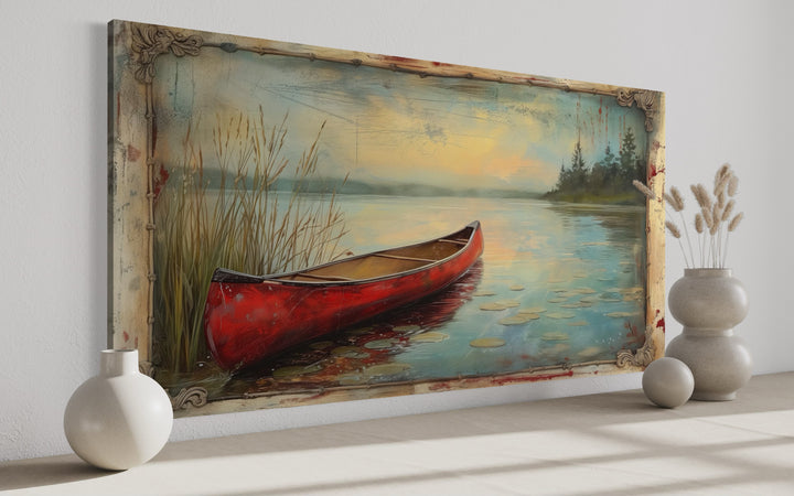 Vintage red canoe on a tranquil lake painting in a rustic antique-style frame for cabin decor.