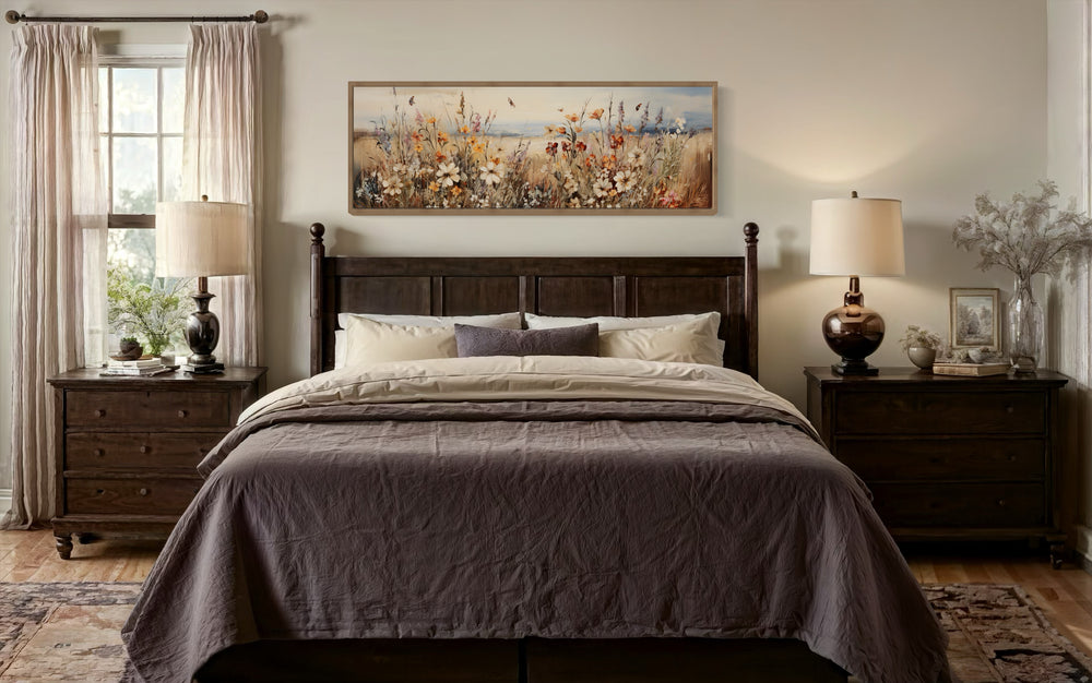 Vintage wildflowers field canvas wall art in a long horizontal frame hanging above a bed.