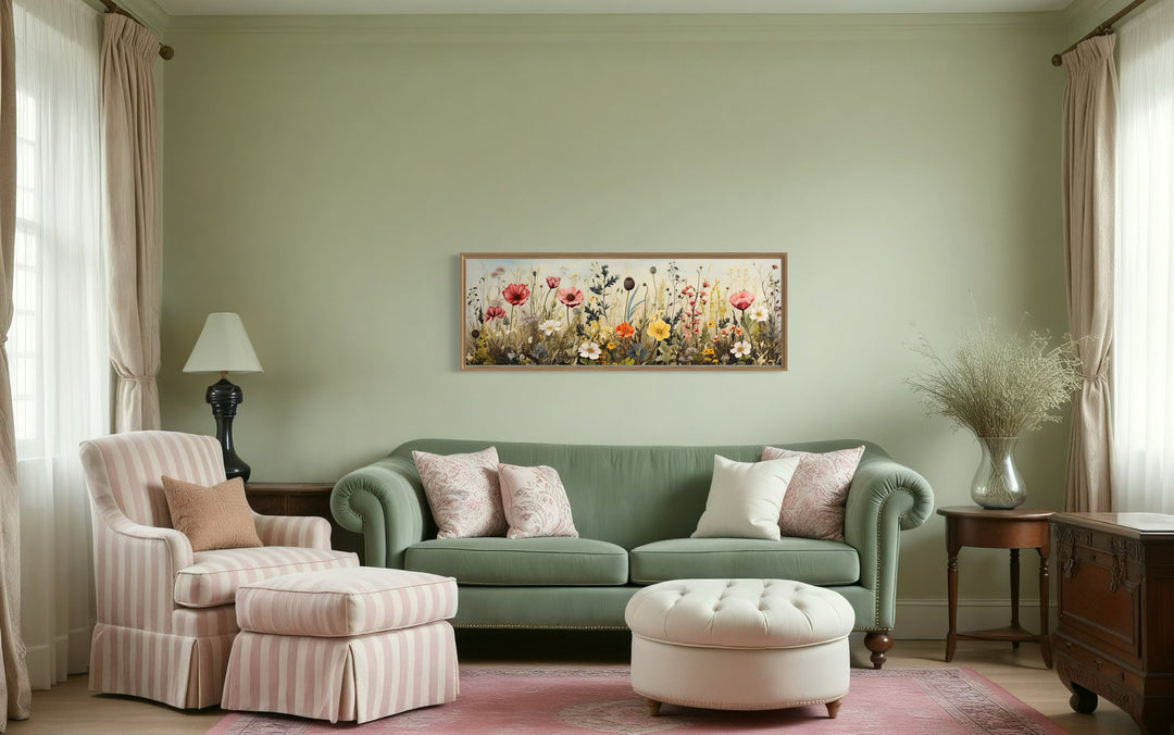 Vintage wildflowers field horizontal framed canvas wall art hanging above a green sofa.
