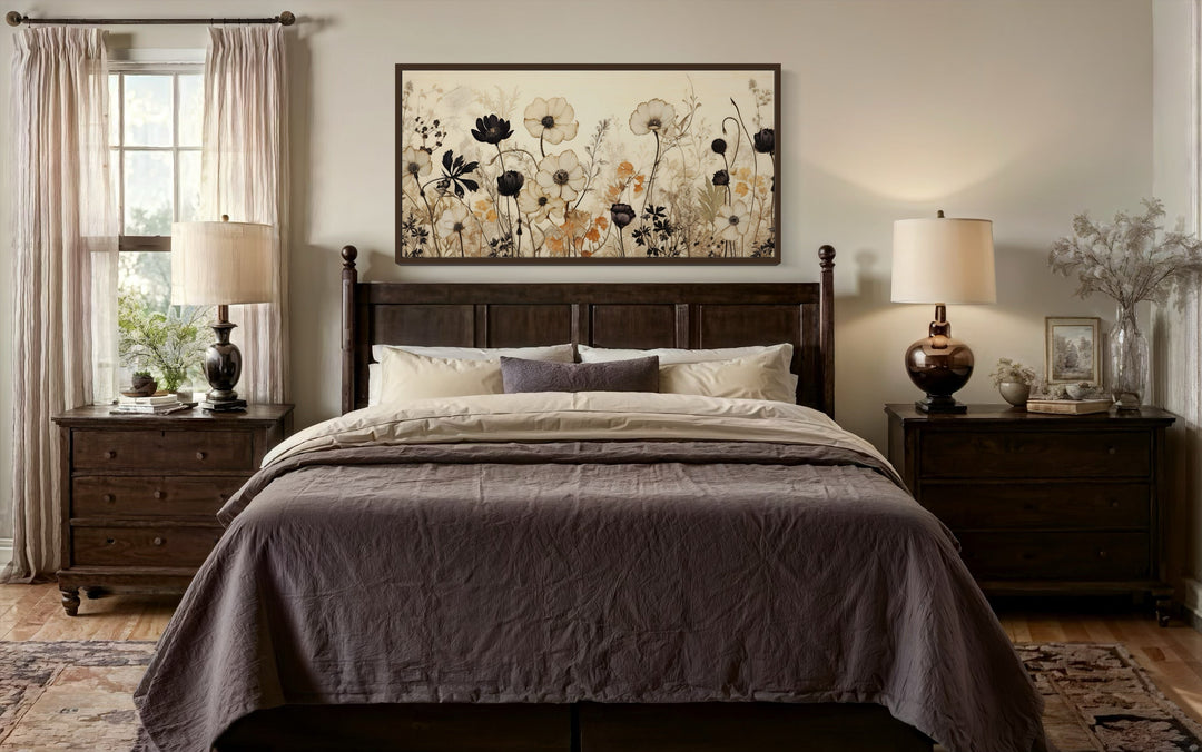 Vintage wildflower canvas wall art with neutral floral silhouettes above a dark wood bed frame.