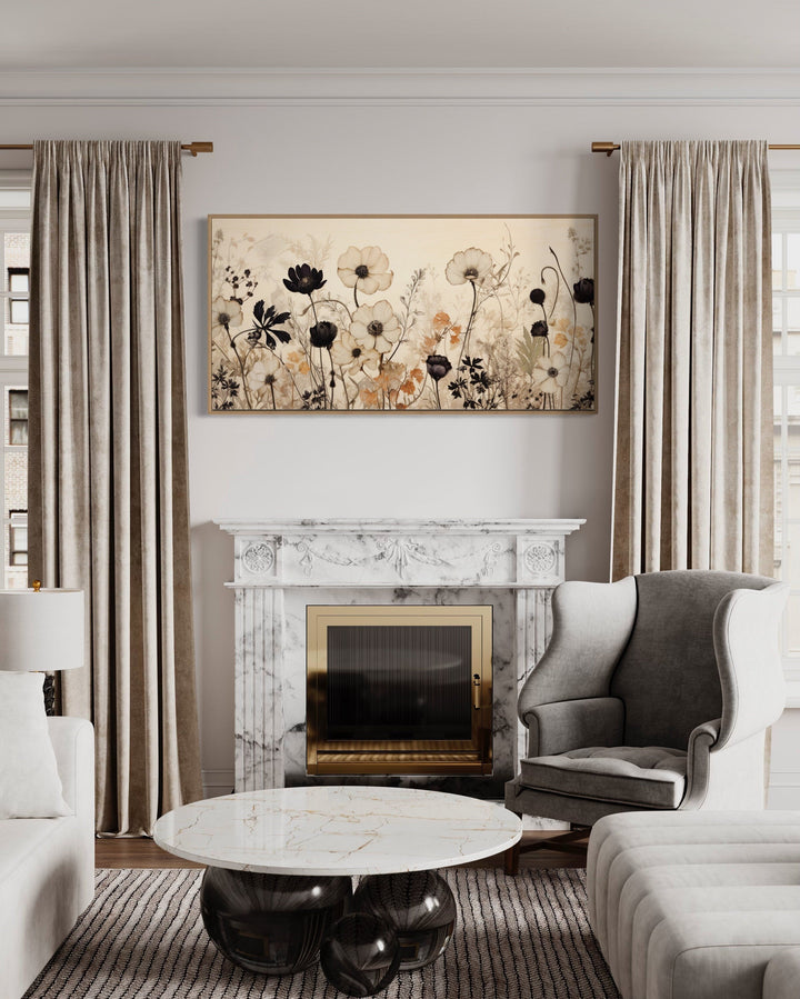 Vintage wildflowers canvas wall art in neutral tones hanging above a marble fireplace mantel.