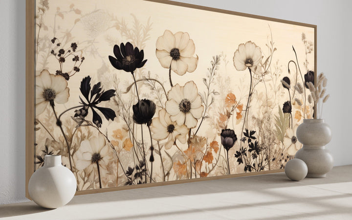 Vintage wildflower canvas wall art with black and neutral floral silhouettes in a farmhouse setting.