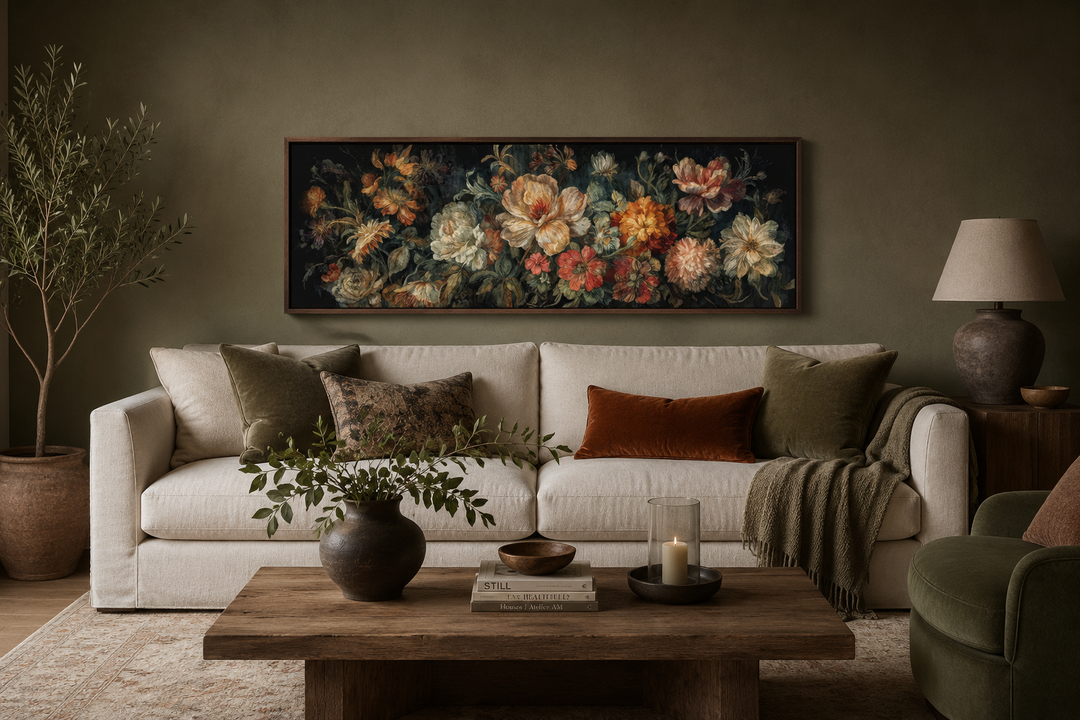 Long horizontal antique style moody floral framed canvas wall art hanging above a cream sofa.