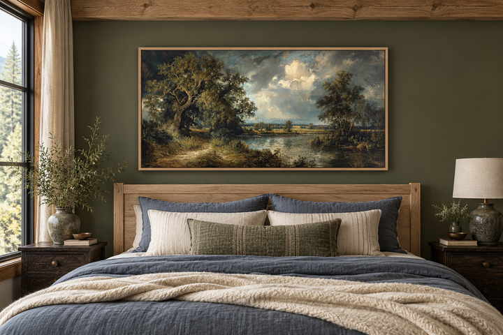 Vintage lake landscape framed canvas wall art hanging above a bed in a rustic bedroom.