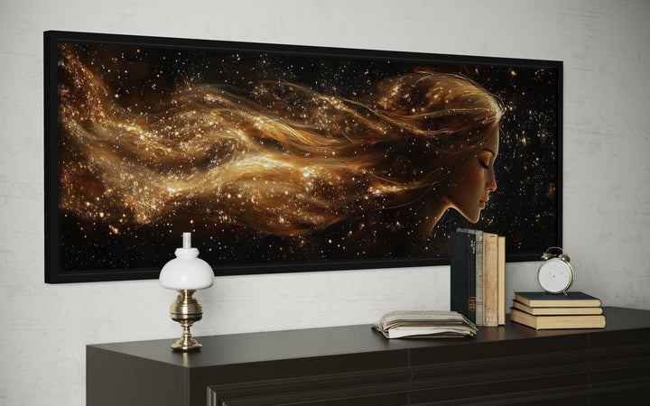 Black and gold celestial canvas art with a woman's profile.