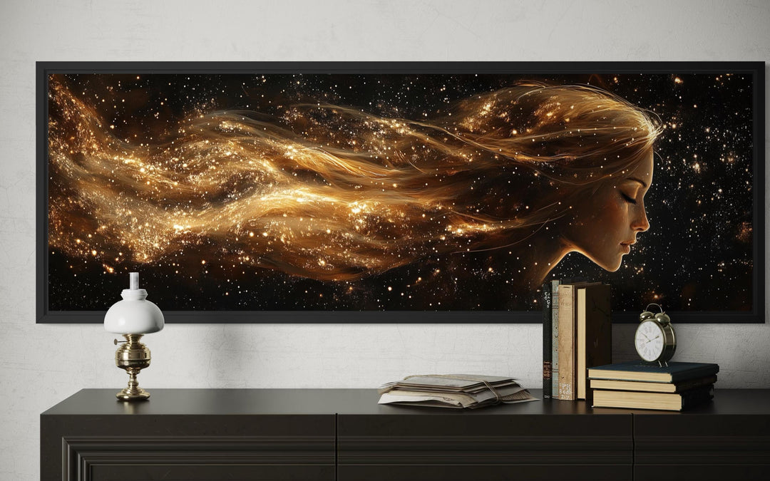Black and gold celestial canvas art with a woman's profile and flowing hair.