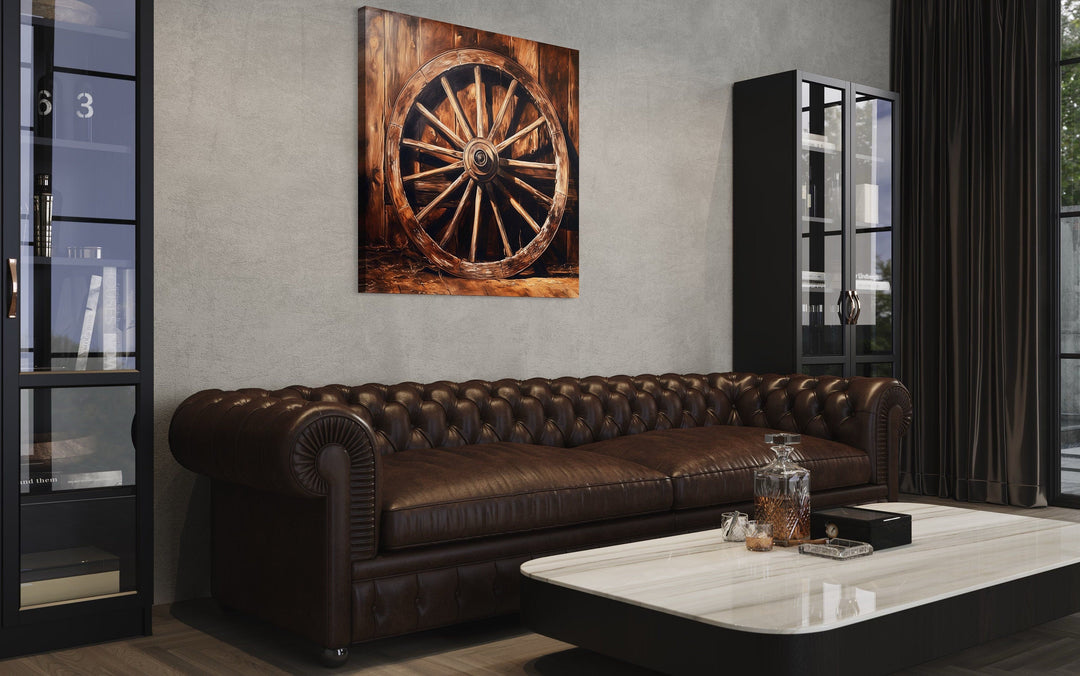 Wagon Wheel Wild West framed canvas wall art hanging above a brown leather tufted sofa.