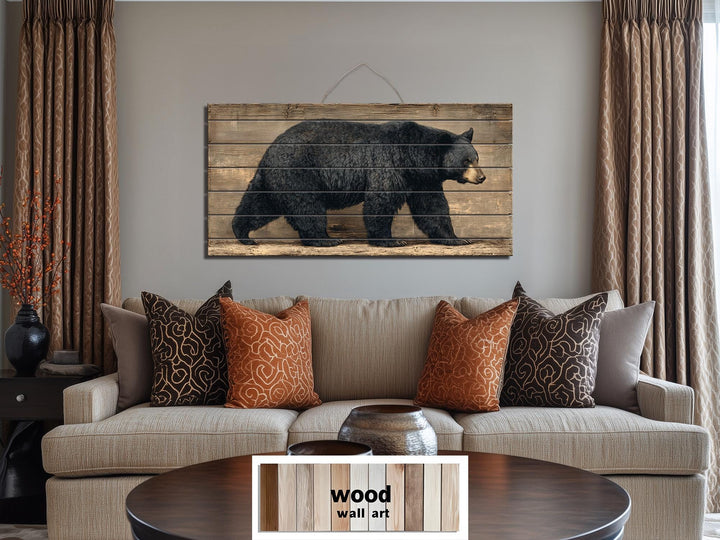 Walking black bear horizontal wood wall art on rustic planks for cabin or hunting lodge decor.