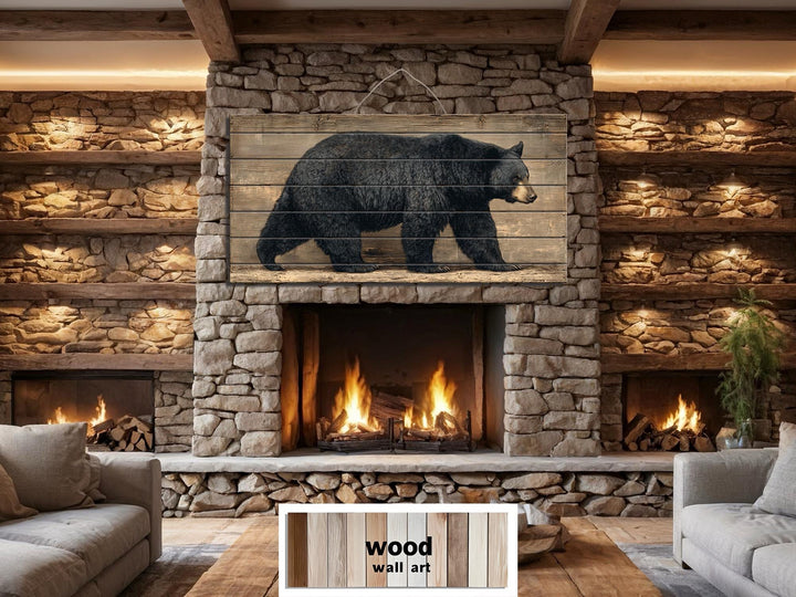 Large horizontal wood wall art featuring a walking black bear on rustic planks above a fireplace.