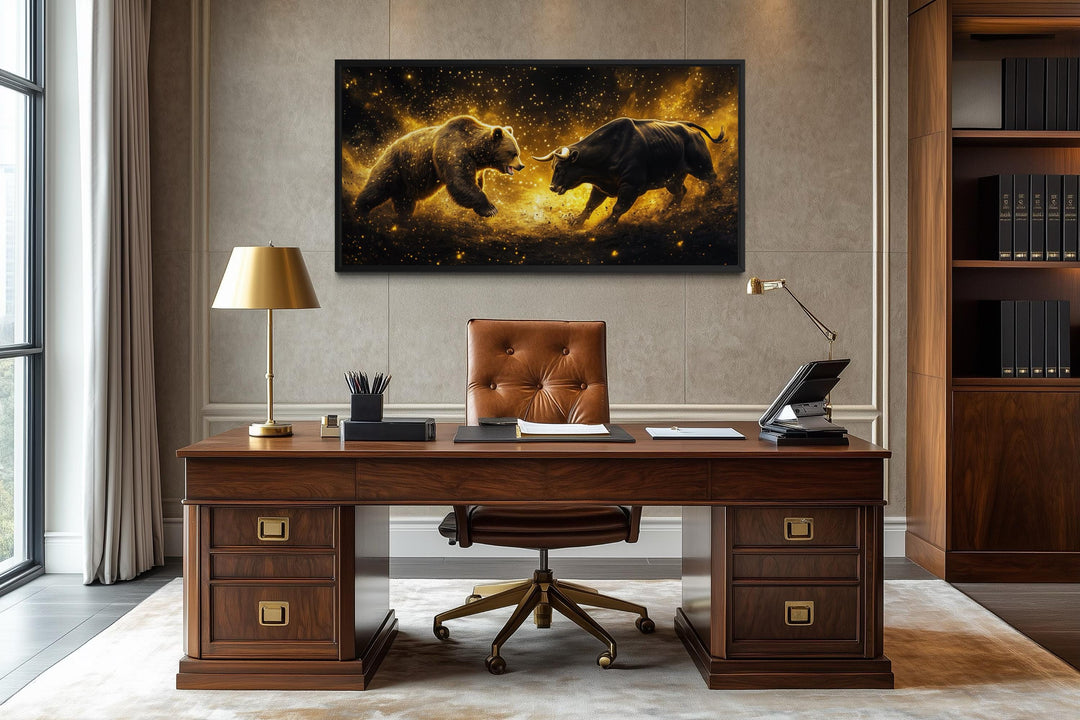A framed canvas of a bull and bear fighting in gold and black hangs above a classic wooden desk.
