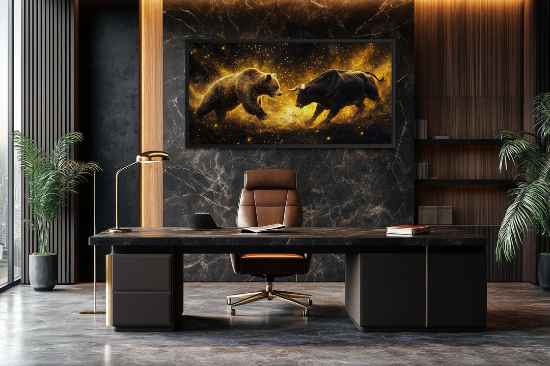 A framed canvas painting of a bull and bear fighting in gold and black hangs in a modern office.
