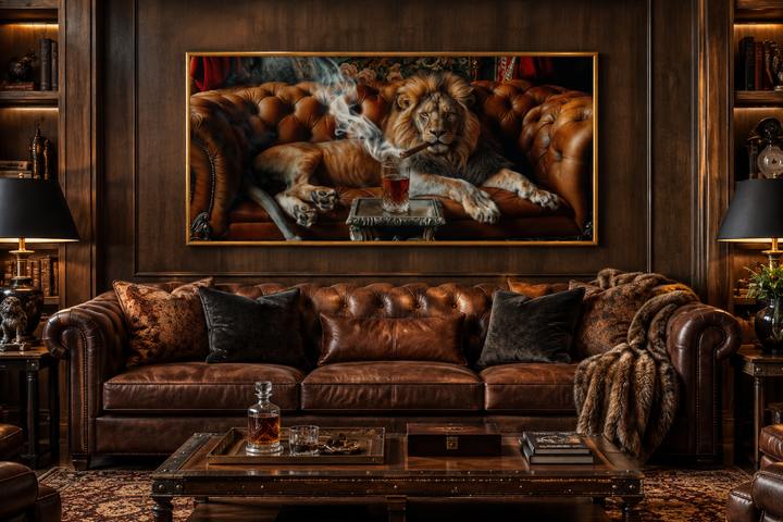 Framed canvas print of a lion smoking a cigar on a couch, hung above a brown leather sofa.