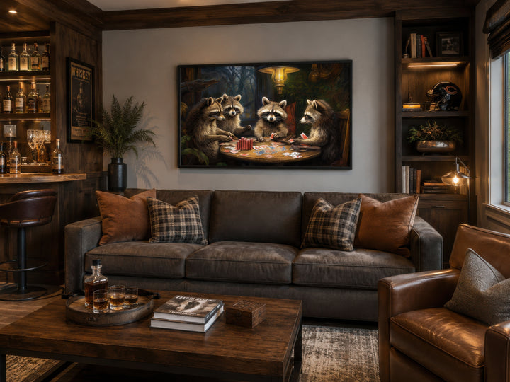 Framed canvas wall art of raccoons playing poker hanging above a brown leather sofa in a man cave.