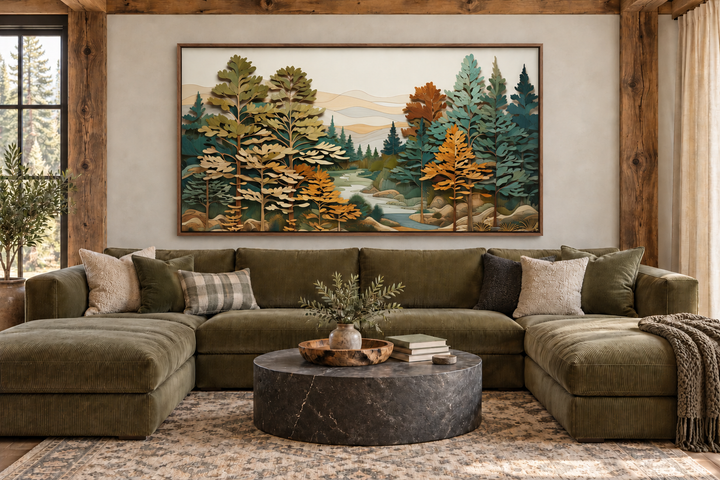 Layered wood wall art of a forest river scene above a green sectional sofa in a rustic living room.