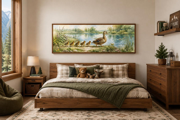Watercolor mother duck and ducklings canvas print hanging above a bed in a nature-themed nursery.