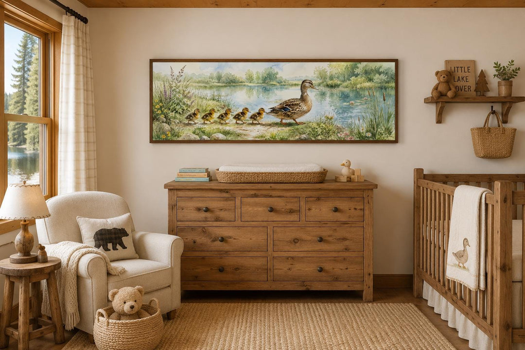 Watercolor mother duck and ducklings canvas print hanging above a dresser in a rustic nursery.