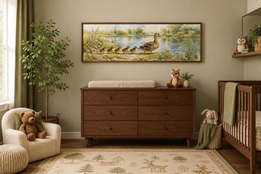 Watercolor mother duck and ducklings canvas print hanging above a dresser in a woodland nursery.