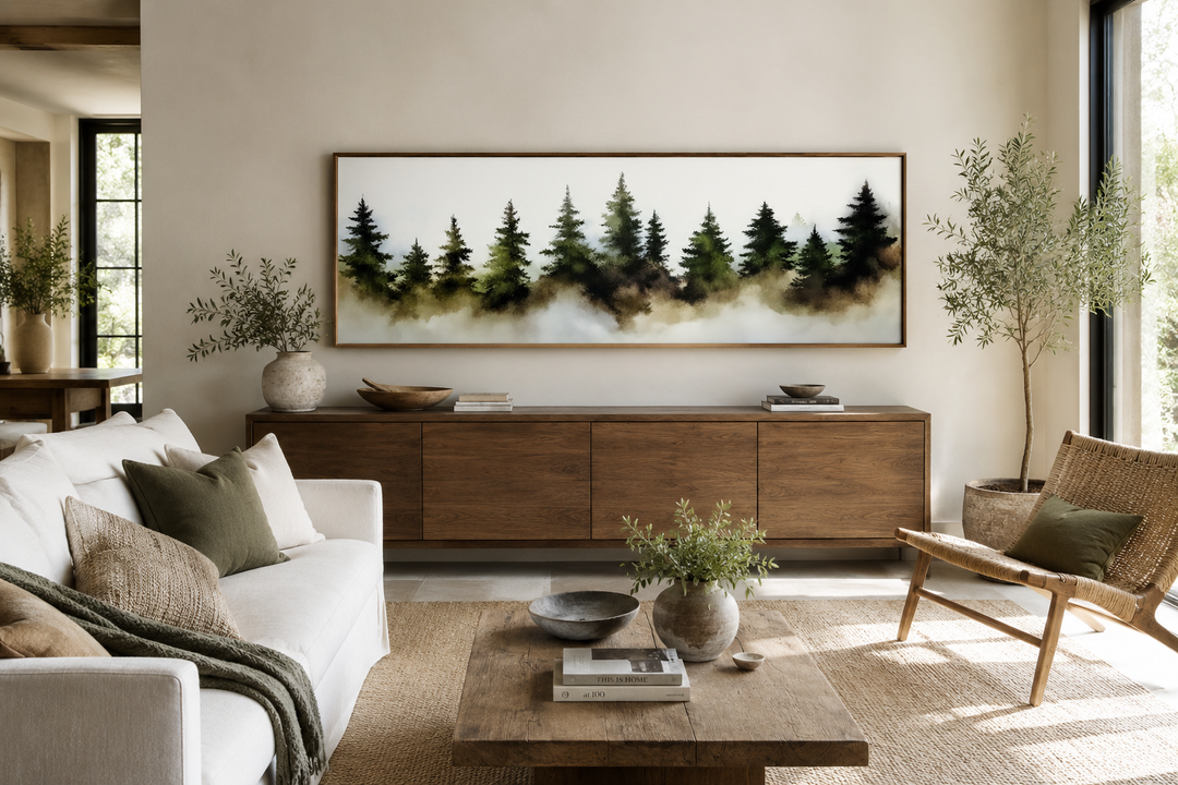 Foggy green pine forest horizontal wall art in a wooden frame above a sideboard in a living room.