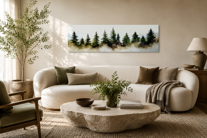Foggy green pine tree forest horizontal canvas wall art hanging above a white sofa in a living room.