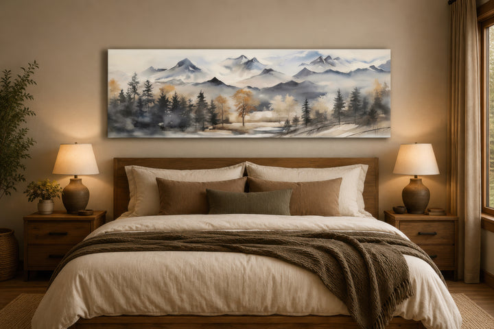 Horizontal mountain landscape canvas wall art in earth tones hanging above a bed.