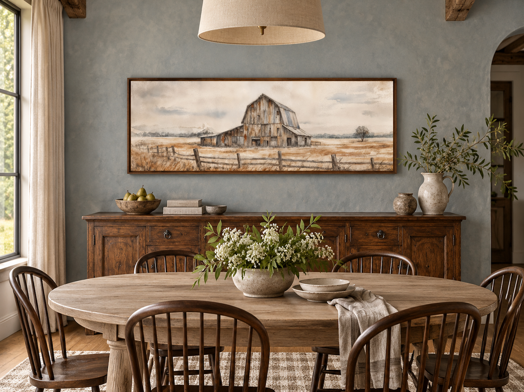 Rustic barn wall art in a long horizontal frame above a wooden sideboard in a farmhouse dining room.