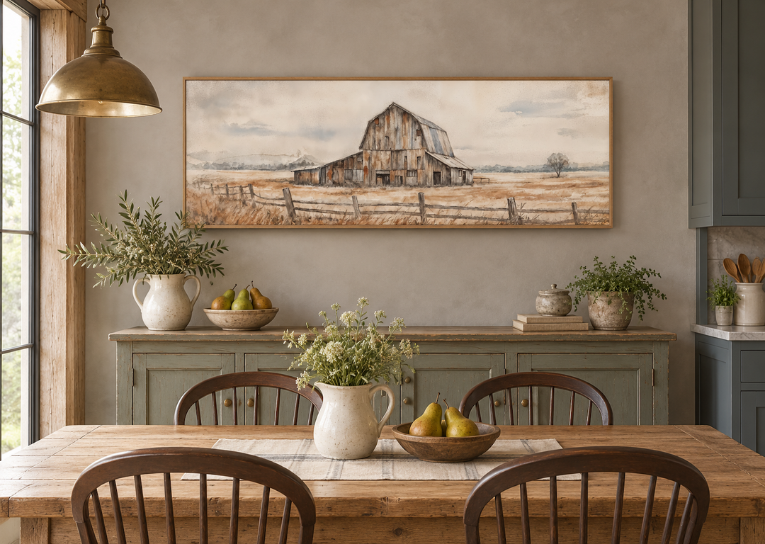 Rustic barn wall art in a long horizontal frame above a sideboard in a neutral farmhouse kitchen.
