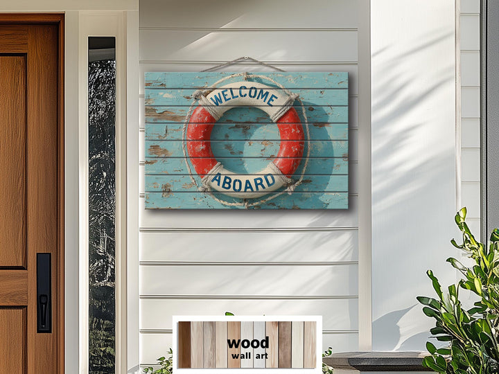 A nautical Welcome Aboard lifebuoy sign printed on distressed blue wood planks for coastal decor.