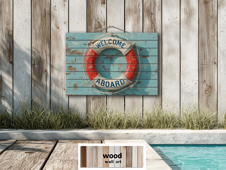 A distressed wood sign featuring a nautical lifebuoy and Welcome Aboard text on a blue plank wall.