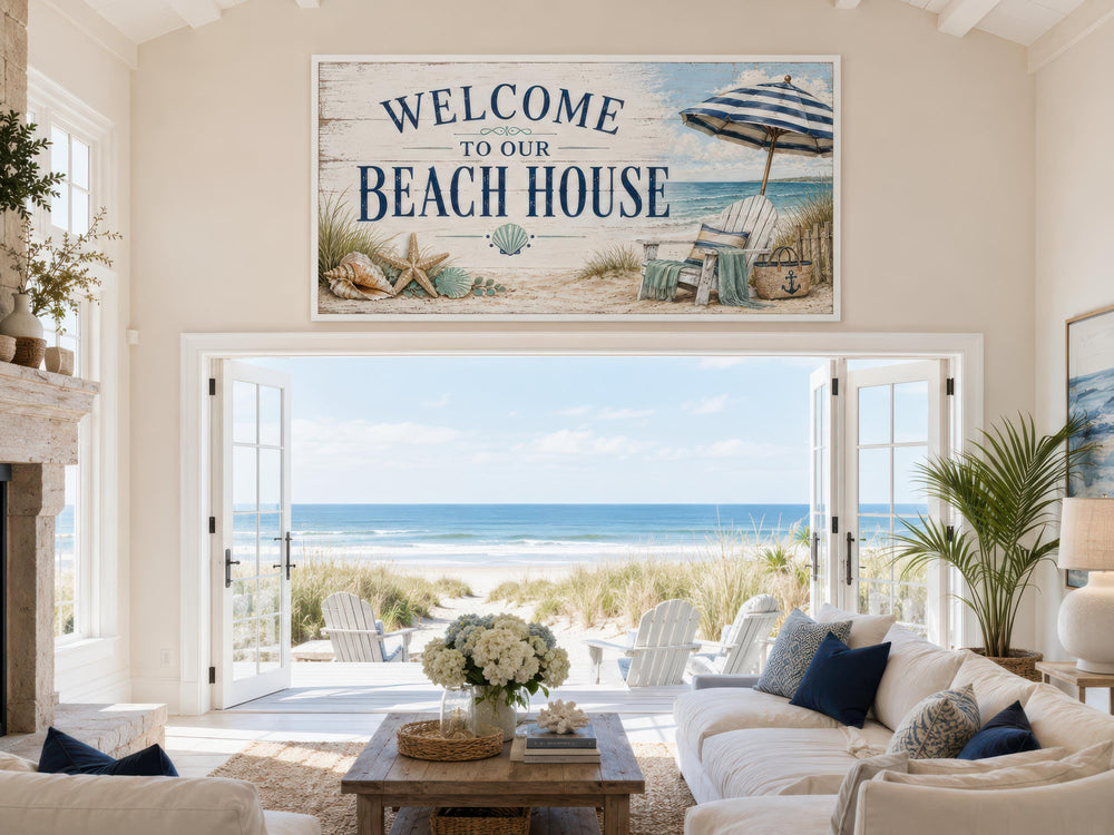 Welcome To Our Beach House rustic canvas print hanging above a doorway in a coastal living room.