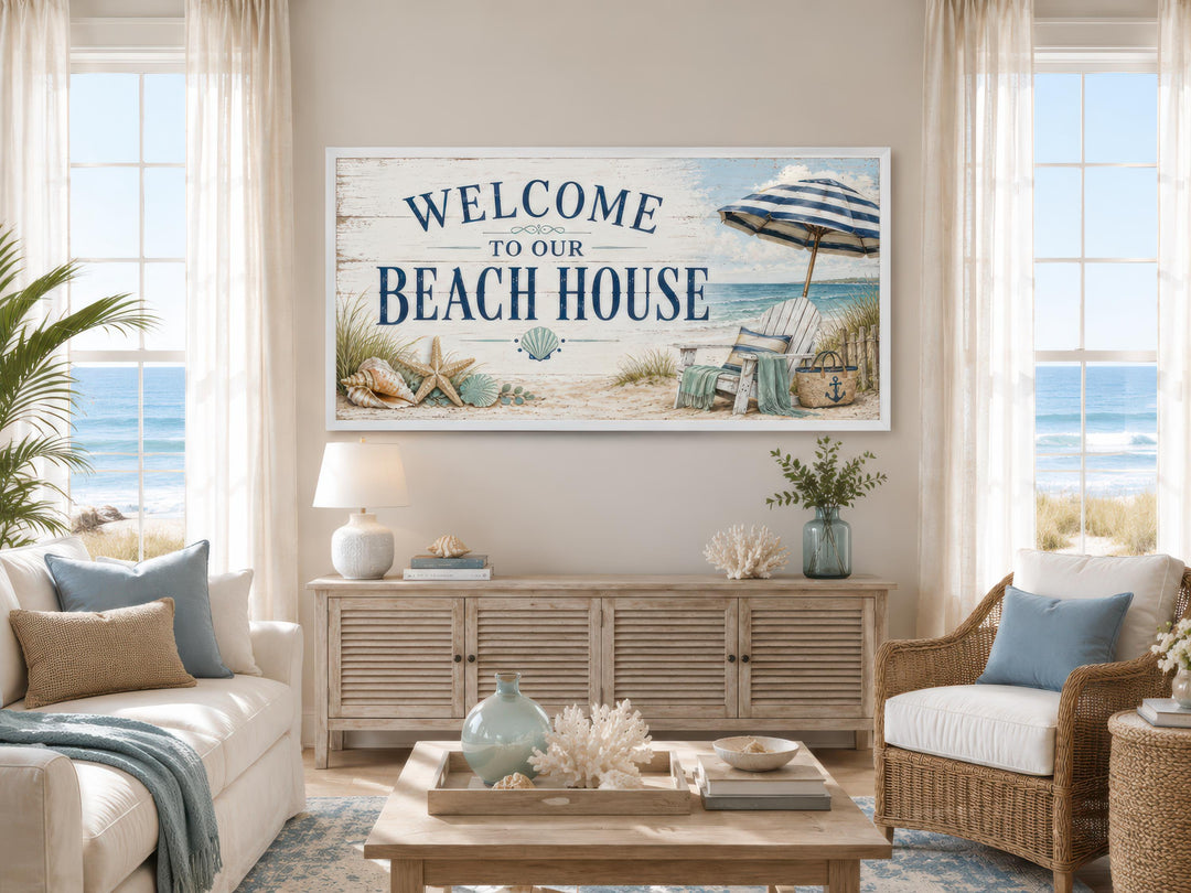 Welcome To Our Beach House rustic canvas print above a sideboard in a coastal living room.