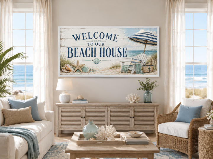 Welcome To Our Beach House rustic canvas print above a sideboard in a coastal living room.