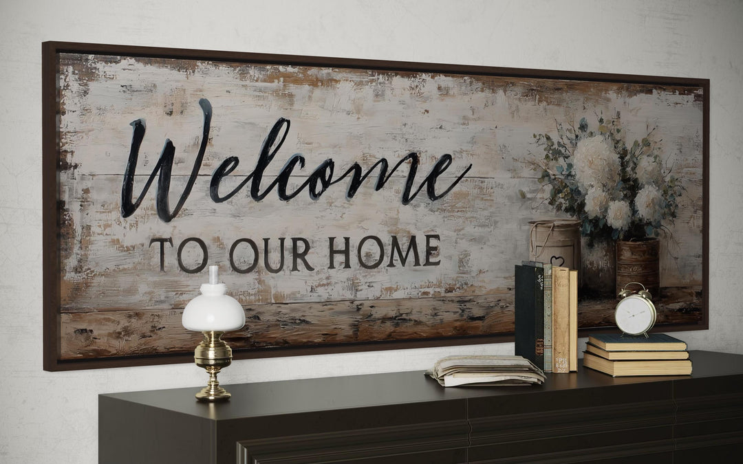Welcome to Our Home long horizontal farmhouse wall art with flowers above a dark wood console table.