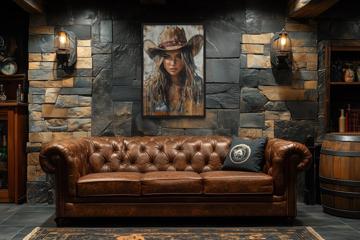 Western Cowgirl Rustic Framed Canvas Wall Art hanging above a brown leather Chesterfield sofa.