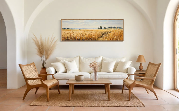 Long horizontal framed canvas wall art of a golden wheat field landscape in a farmhouse living room.