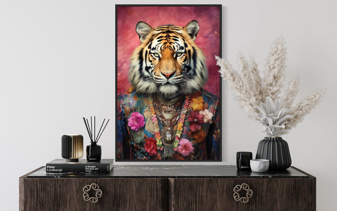 Framed canvas wall art of a tiger in a floral pink suit above a dark wood dresser.