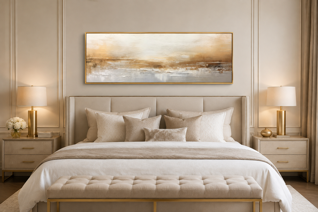 Long narrow horizontal abstract wall art in white and gold hanging over a bed in a neutral bedroom.