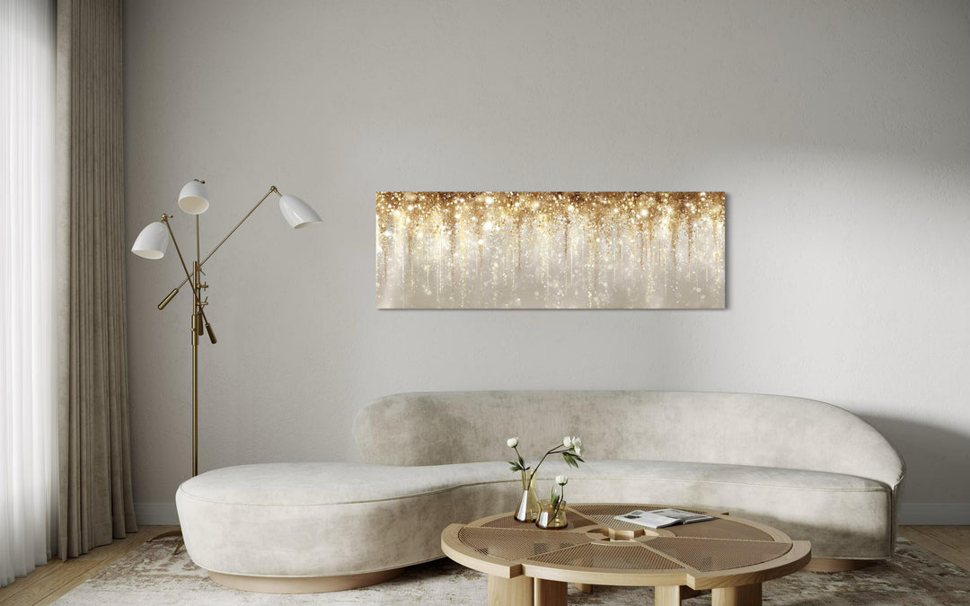 White and gold abstract rain canvas wall art hangs above a modern curved sofa in a neutral room.