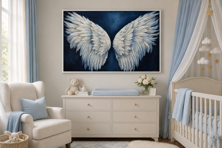 Framed canvas wall art of white angel wings on a dark blue background in a nursery.