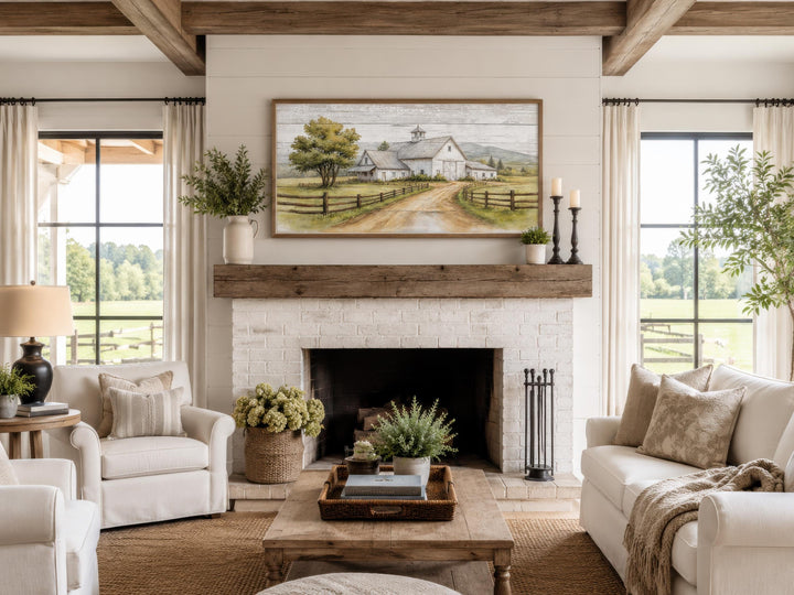 White barn wall art in a rustic farmhouse living room above a white brick fireplace mantel.