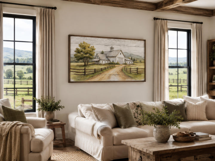 White barn wall art in a rustic farmhouse living room with a white sofa and wooden coffee table.
