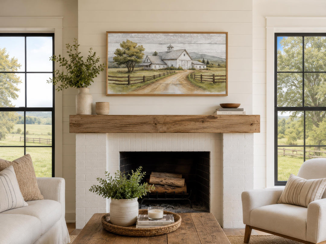 Rustic white barn wall art in a wooden frame hanging above a white brick fireplace mantel.