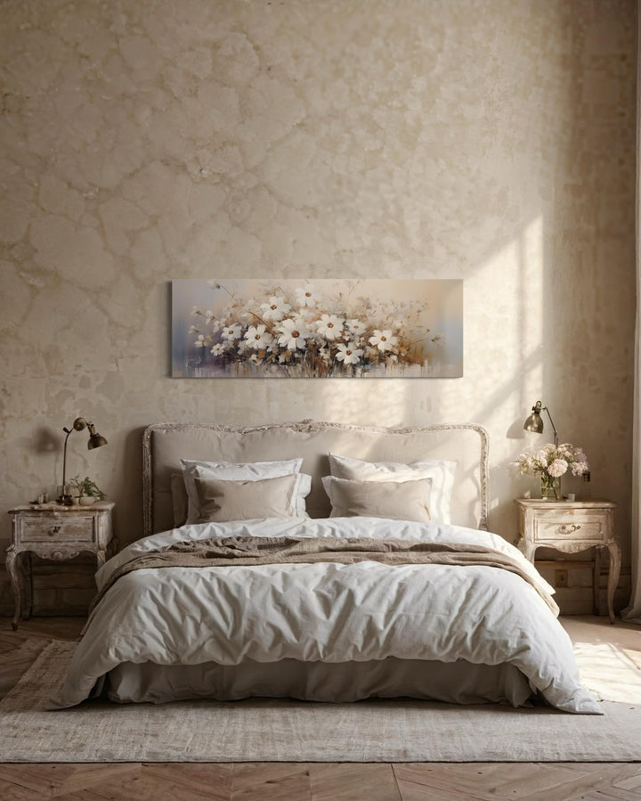 White beige neutral wildflowers farmhouse framed canvas wall art hanging above a bed.