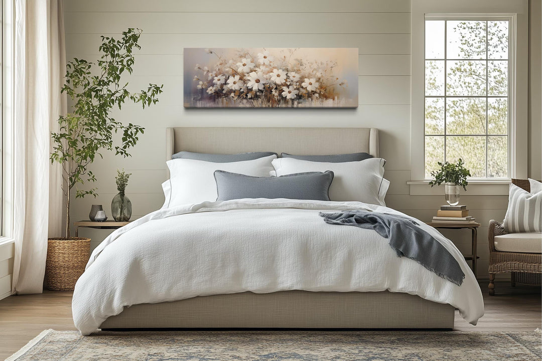 White beige neutral wildflowers farmhouse framed canvas wall art hanging above a bed.