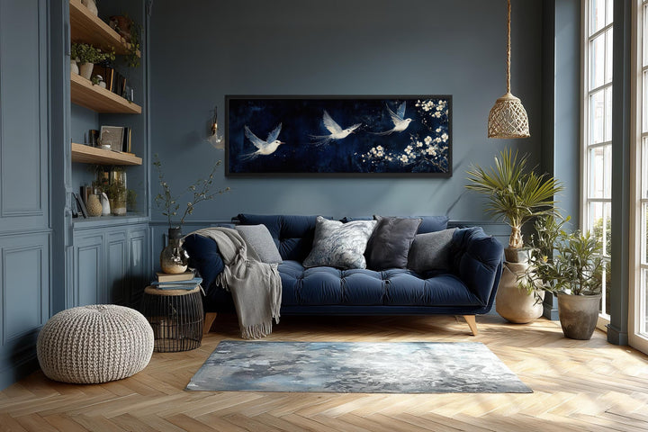 Long narrow canvas wall art featuring white birds in flight against a navy blue floral background.