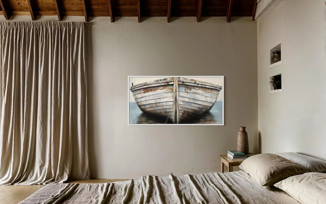 A rustic framed canvas wall art featuring a close-up of a weathered white and brown boat.
