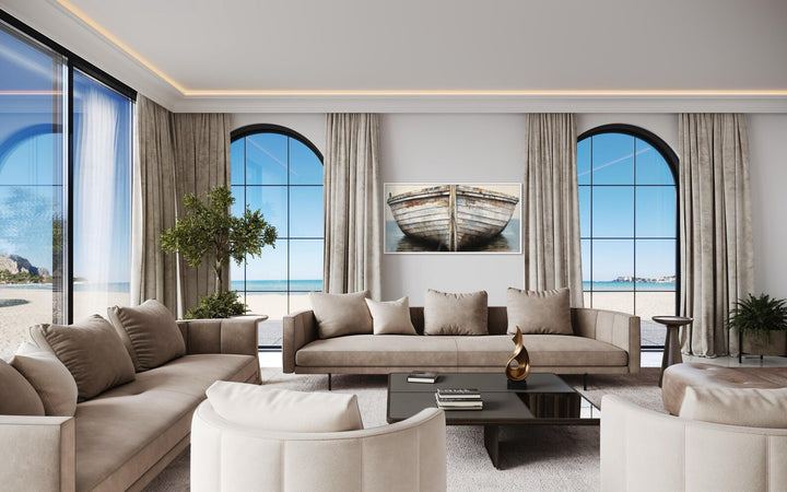 Framed canvas wall art featuring a rustic old boat in a modern living room with coastal views.