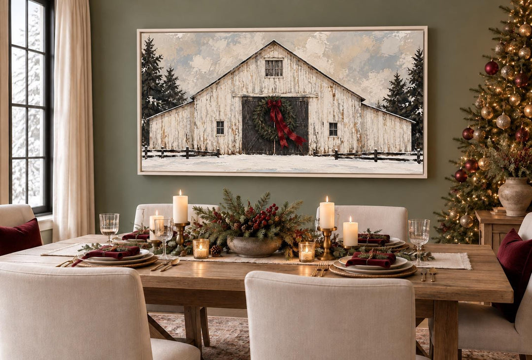 White Christmas Barn framed canvas wall art above a festive dining table with holiday decor.